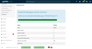 Screenshot der Gambio-Adminoberfläche im Bereich ‚Bestellarchiv‘: Eine Mitteilung zeigt, dass 84 845 Bestellungen archiviert wurden, was 84,27 % der aktuellen Bestellungen entspricht. Darunter befindet sich ein grüner Fortschrittsbalken und eine Tabelle mit archivierten Einträgen wie ‚orders‘, ‚coupon_gv_queue‘, ‚orders_parcel_tracking_codes‘ und weiteren.